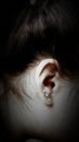 Black and white photo of an ear with earrings Royalty Free Stock Photo