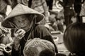 Black and white photo of an elderly woman at market