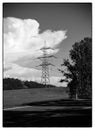 Black and white photo of Electricity tower in sunny day on the cloudy beautiful sky Royalty Free Stock Photo