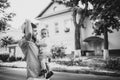 Black and white photo. Father and son walk in old city street. City road with old bulding and big trees on the background Royalty Free Stock Photo