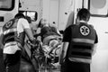 Female young victim of the accident lies on a stretcher in an ambulance Royalty Free Stock Photo