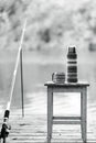 Black-and-white photo. Fishing on the river. A fishing rod and a