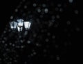 Black and white photo of a flashlight in bokeh. Abstract background of night city with selective focus Royalty Free Stock Photo