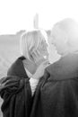 Black and white photo, focus on elderly wife with husband wearing plaid. Royalty Free Stock Photo