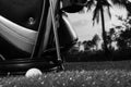 Black and white photo of golf clubs and a golf ball in low light Royalty Free Stock Photo