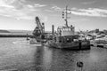 Black and White photo of Grab Dredger C H Horn at work dredging Poole Harbour marina Royalty Free Stock Photo