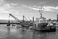 Black and White photo of Grab Dredger C H Horn at work dredging Poole Harbour marina Royalty Free Stock Photo