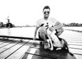Black and white photo of a happy young man and his dog traveling together Royalty Free Stock Photo