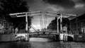 Black and White photo of a Historic Draw Bridge over the Nieuwe Herengracht at the Amstel Canal in the old city of Amsterdam Royalty Free Stock Photo