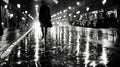 A black and white photo of a lone figure walking down a rainsoaked street with the reflections of the city lights Royalty Free Stock Photo