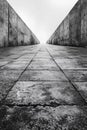 A black and white photo of a long walkway with concrete walls, AI Royalty Free Stock Photo