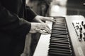 Black and white photo of man`s hand playing on electronic keyboards. Shallow depth of field. Music, entertainment Royalty Free Stock Photo