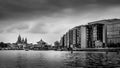 Black and White Photo of Modern Office Buildings and a floating Chinese Restaurant along the Harbor named Het IJ Royalty Free Stock Photo