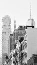 Black and white photo of modern and old buildings with fire escapes, New York, USA Royalty Free Stock Photo