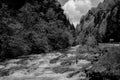 Black and white photo of a mountain fast cold river