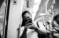 Black and white photo: People traveling by BTS Skytrain in Bangkok must wear a face mask to prevent COVID 19 outbreak in Bangkok