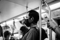 Black and white photo: People traveling by BTS Skytrain in Bangkok must wear a face mask to prevent COVID 19 outbreak in Bangkok