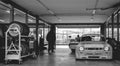 Black and white photo of the pits of a circuit with a Ford Escort 1600 RS and a 2002 BMW inside and the time board prepared in the Royalty Free Stock Photo