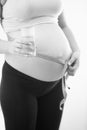 Black and white photo of pregnant woman holding glass of water a Royalty Free Stock Photo