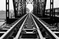 A black and white photo of a railway track on a steel bridge in Taling Chan district, Bangkok. Royalty Free Stock Photo