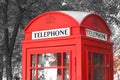 Black and white photo with red telephone booth in classic english style Royalty Free Stock Photo