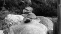 A black and white photo of rocks stacked on a larger rock. Royalty Free Stock Photo