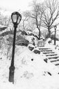 Black and White Photo of Rocky Stairs Going Up and Street Lights Covered in Snow at Central Park during the Winter in New York Cit Royalty Free Stock Photo
