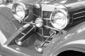 Black and white photo with round headlight of old retro car on black and white background in style of old vintage black and white Royalty Free Stock Photo