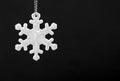 Black and white photo of safety reflector in the form snowflakes. Necessary equipment to pedestrians for walks during