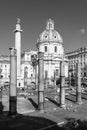 Black and white photo showing ancient roman pillars standing in front of exterior facade of roman catholic church Royalty Free Stock Photo