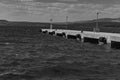 Black and white photo showing an empty port with a pier overlooking the sea and a berth for ships Royalty Free Stock Photo