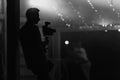 black white photo. Silhouette of cameraman standing with video action film production digital camera at wedding Royalty Free Stock Photo