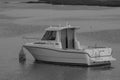 Black and white photo of a small motorboat
