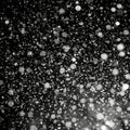 Black and white photo of snow falling from the sky Royalty Free Stock Photo
