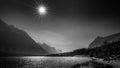 Black and White Photo of the sun setting over Lake Sherburne in Glacier National Park