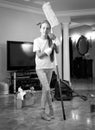 Black and white photo of teenager girl cleaning house with swab Royalty Free Stock Photo