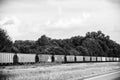 Line of Boxcars along a Highway Royalty Free Stock Photo