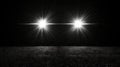 A black and white photo of two bright lights in the dark Royalty Free Stock Photo