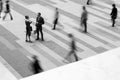 Black and White photo of two business people talking in blurred crowd