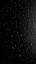 a black and white photo of water drops on a window pane with a black background and a white light in the middle of the photo Royalty Free Stock Photo