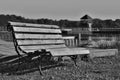 Black and white photo of wooden bench at the Alum Lake Kamencove jezero in Chomutov city in the foothills of the Krusne hory Mount Royalty Free Stock Photo