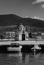 Black & White Photograph of Aghios Nikolaos Orthodox Church and Mediterranean Fishing Boats on Water in Euboea - Nea Artaki, Greec Royalty Free Stock Photo