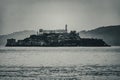 Black and white photograph of the alcatraz jail as seen from pier 39 of the fisherman\'s wharf in San Francisco bay.