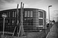 a black and white photograph of the building near some trees Royalty Free Stock Photo