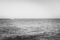 Black-white photography. Alone blurred boat or ship in silent sea or ocean water Royalty Free Stock Photo