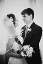 Black white photography beautiful young couple standing near the window Royalty Free Stock Photo