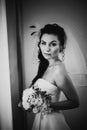 Black white photography beautiful young happy bride standing near the window Royalty Free Stock Photo