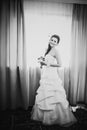 Black white photography beautiful young happy bride standing near the window Royalty Free Stock Photo