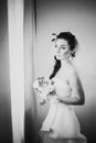 Black white photography beautiful young happy bride standing near the window Royalty Free Stock Photo