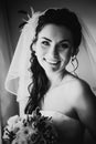 Black white photography beautiful young happy bride standing near the window Royalty Free Stock Photo